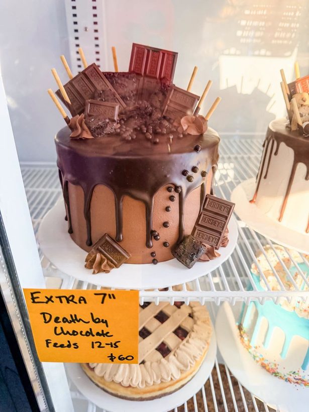 A Death by Chocolate drip cake in the case at So Many Somethings